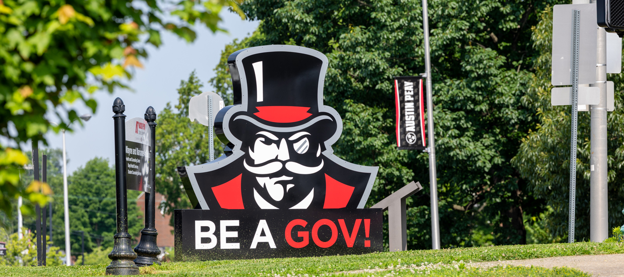 Large sign on the corner of University and College street that has the Gov mascot and says Be a Gov!