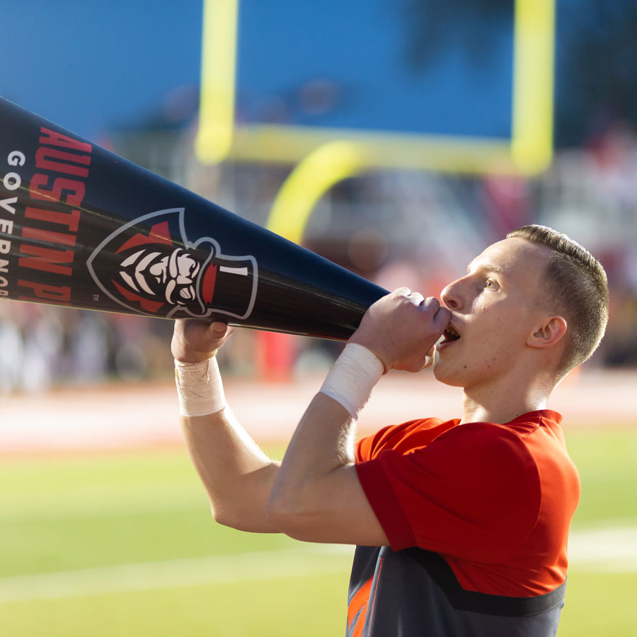 Cheerleader telling into a megaphone