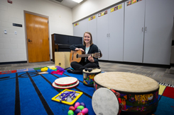 Music therapy student sitting behind a row of instruments