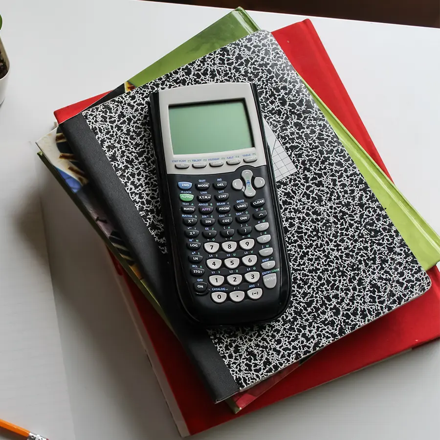 Graphing calculator on stacked notebooks