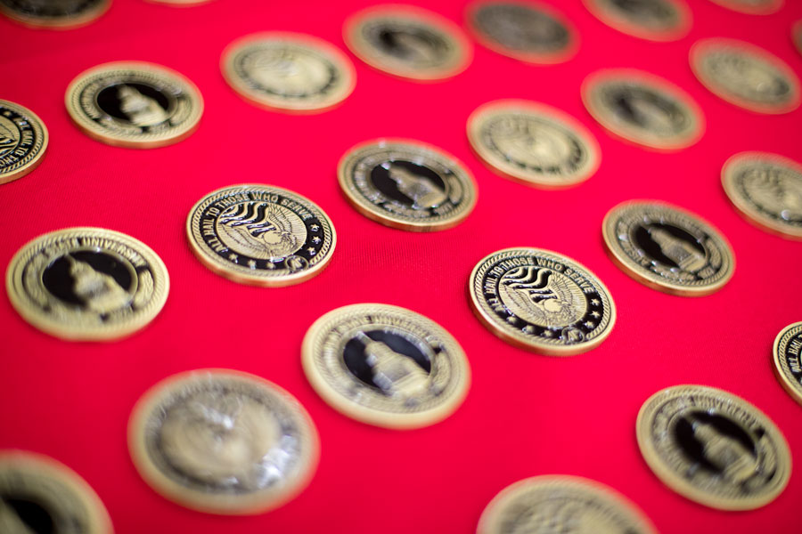 Military coins laid out on a table for the ceremony.