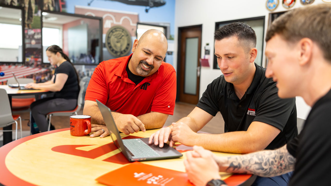 two students talking with a career counselor