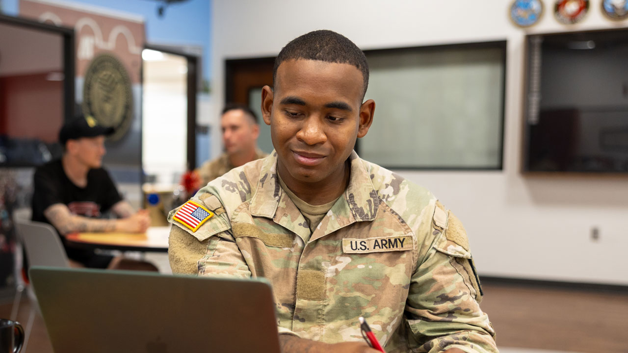 Military student studying the Newton Military Family Resource Center.