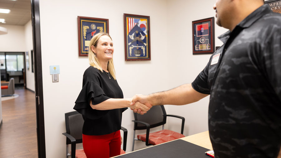 student shaking advisors hand