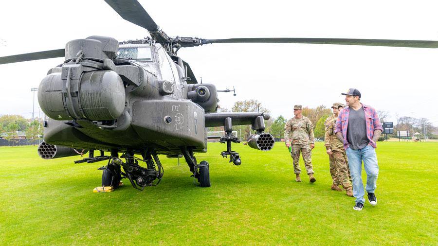 students walking around a helicopter
