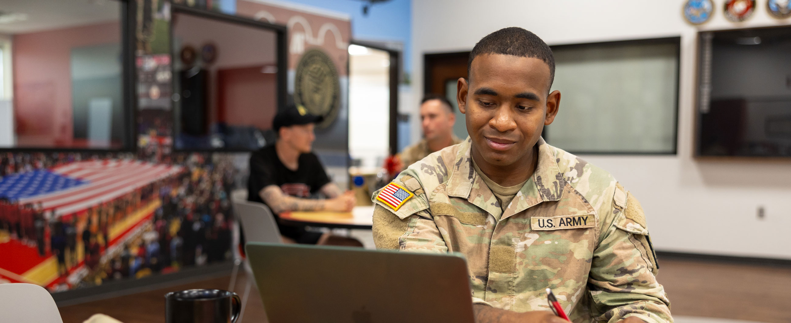 Military student working on their laptop.