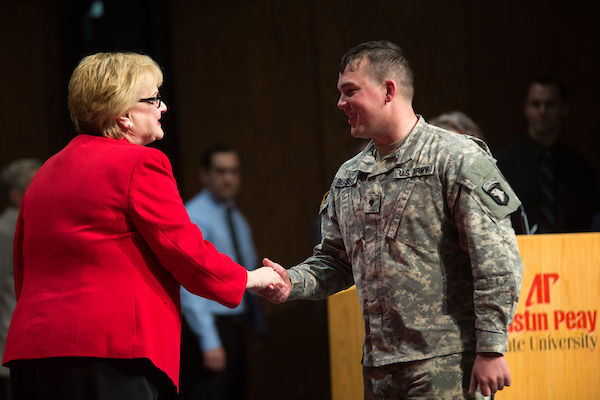 APSU President Alisa White shakes hands with an active-duty soldier about to graduate from APSU.