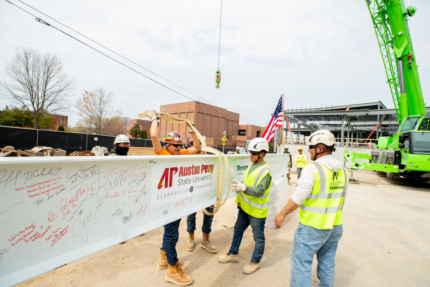 Workers prepare to place the final girder of APSU’s upcoming Health Professions Building during a topping out ceremony. | Photo by Sean McCully 