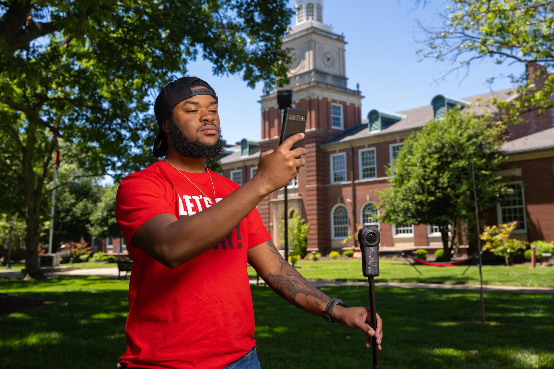 Senior psychology major Robert Taylor, a temporary worker at APSU's GIS Center, works with the camera equipment he used to design a virtual Habitat for Humanity home tour. 