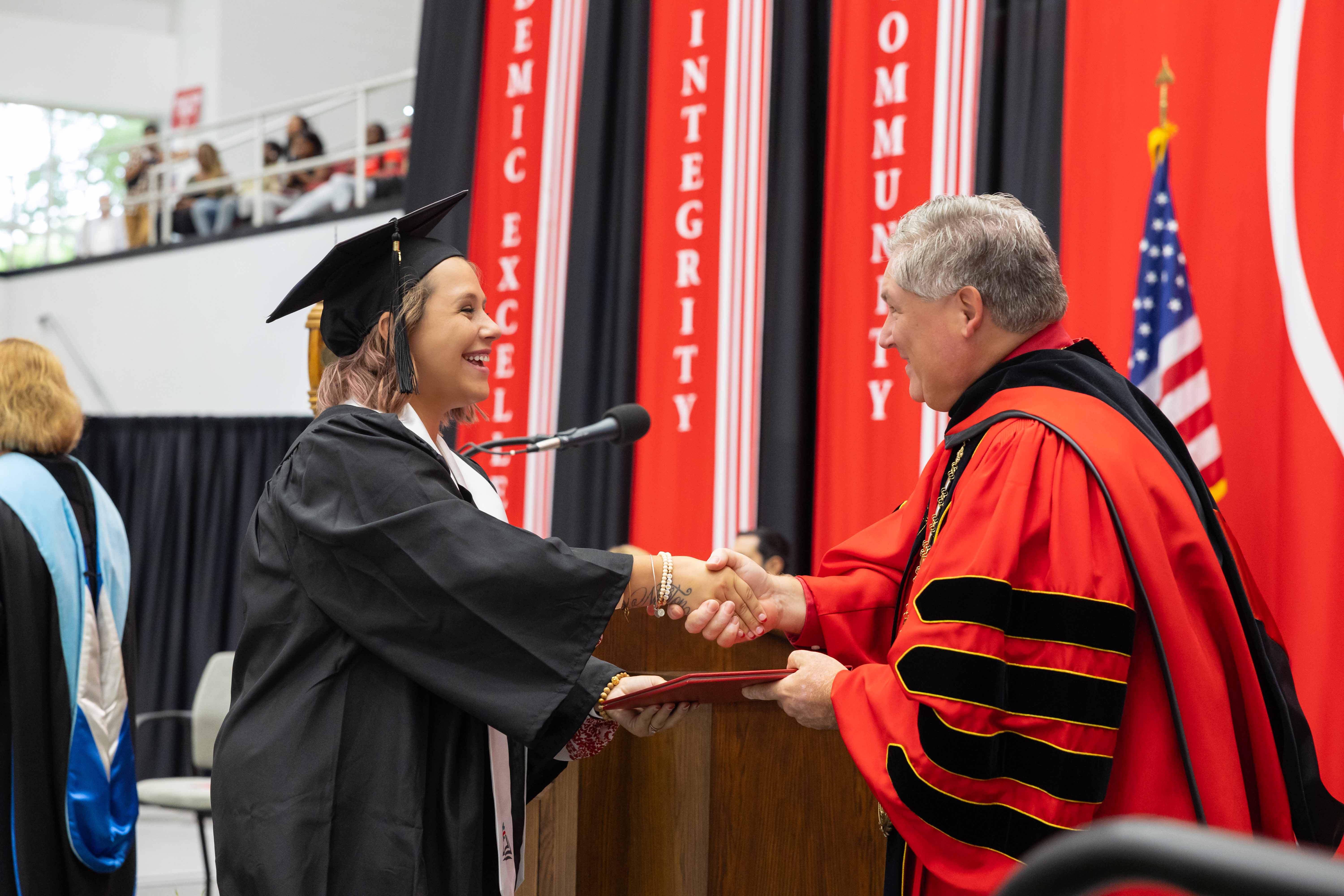 Senior education major Taylor Newton receives a diploma from APSU President Michael Licari during a commencement ceremony on Aug. 2.