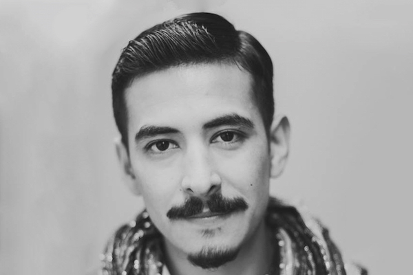 A black and white headshot of Castillo