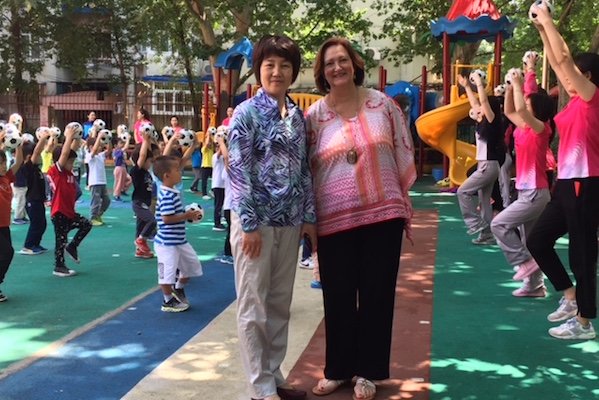 Dr. Bruster meets with a kindergarten teacher in Chin.a