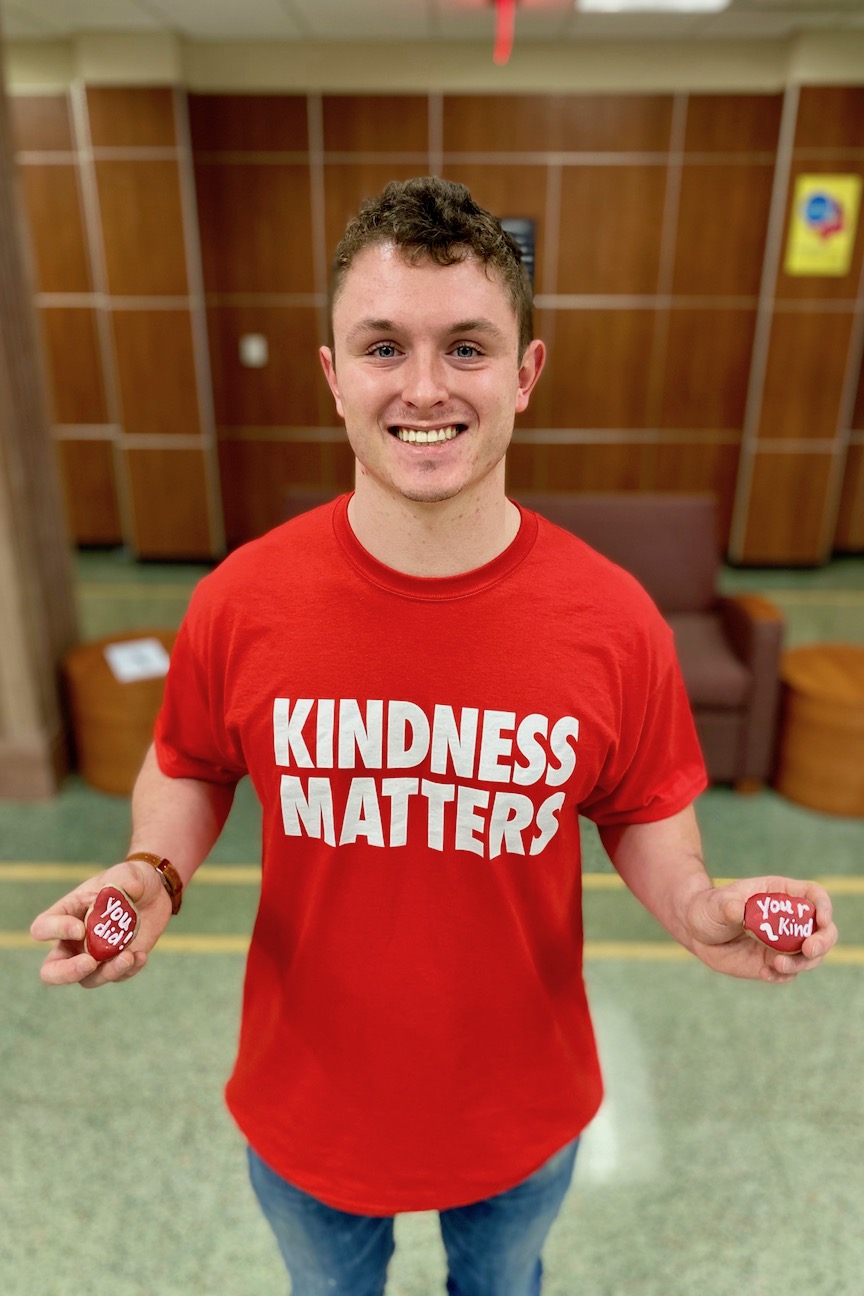 Blake Burch holds two of the civility rocks students in the School of Nursing will award to each other during the semester.
