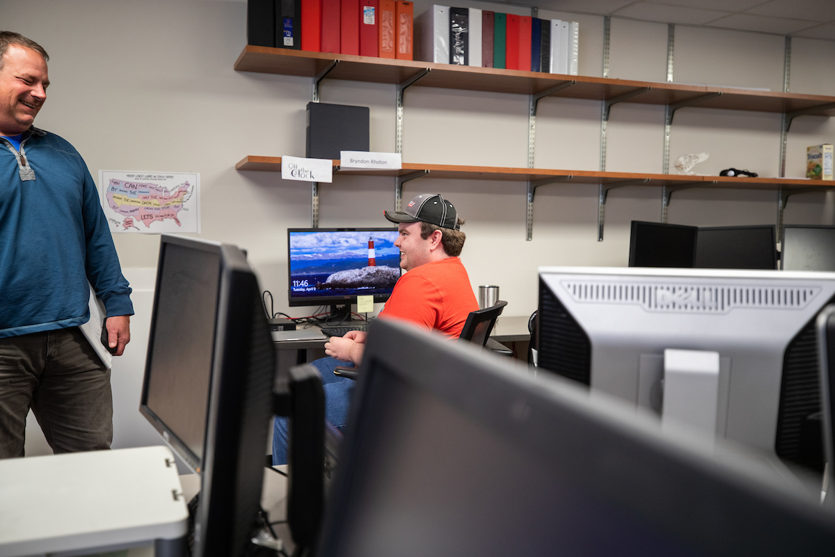 GIS Center Project Manager Doug Catellier jokes with Rhoton at the GIS Center.