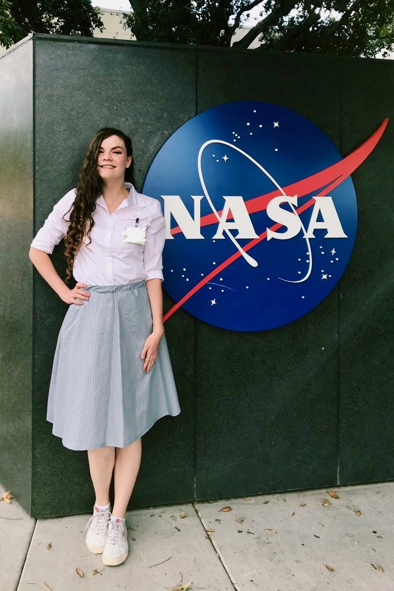 Gulledge stands in of the NASA Jet Propulsion Laboratory’s sign, where she was an intern earlier this year, working on real time atmospheric correction for ground-based telescopes.