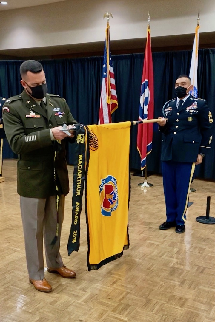 COL Brent Clemmer, U.S. Army, Commander – 7th ROTC Brigade, placing the MacArthur Award streamer on the APSU Army ROTC colors, held by MSG Marcus Gurule, U.S. Army, APSU Army ROTC Senior Military Instructor.