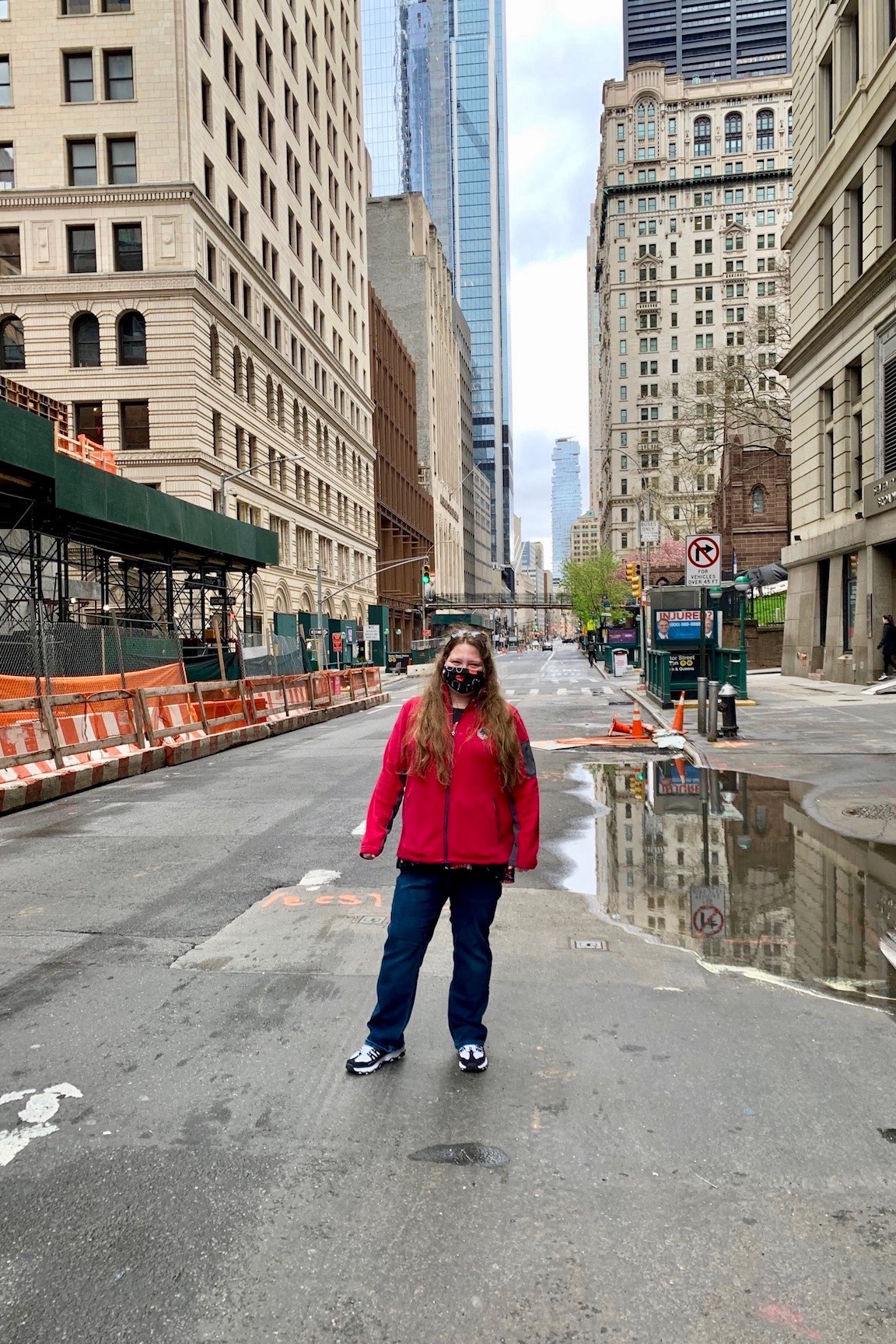 After work one day, Sullivan ventured to the World Trade Center site. Here, she stands on an abandoned street near the site. The new World Trade Center building stands in the background.