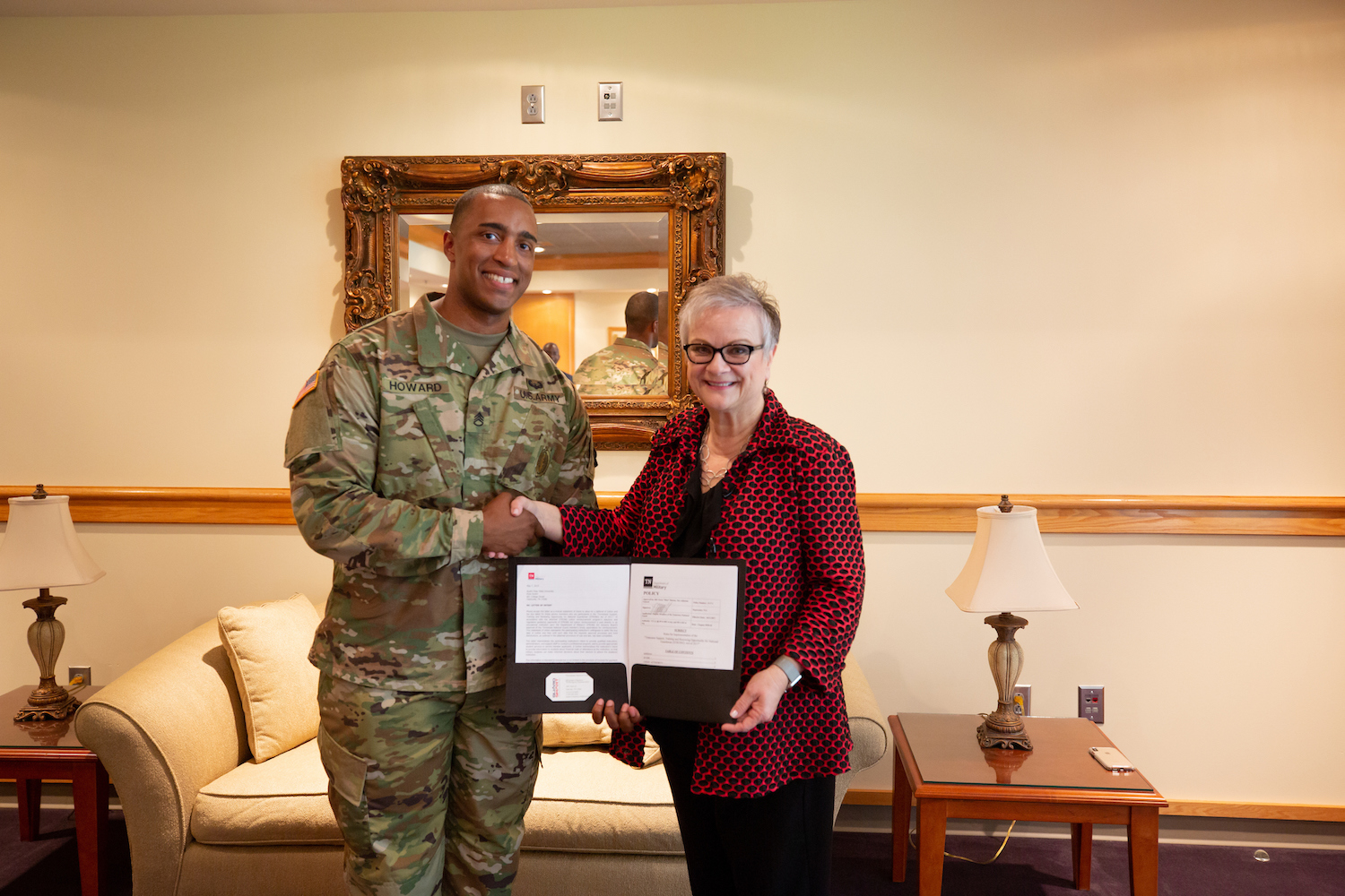 Staff Sgt. Michael Howard, APSU military science instructor and Army National Guard recruiter, and APSU President Dr. Alisa White hold the Tennessee STRONG Act deferment agreement.