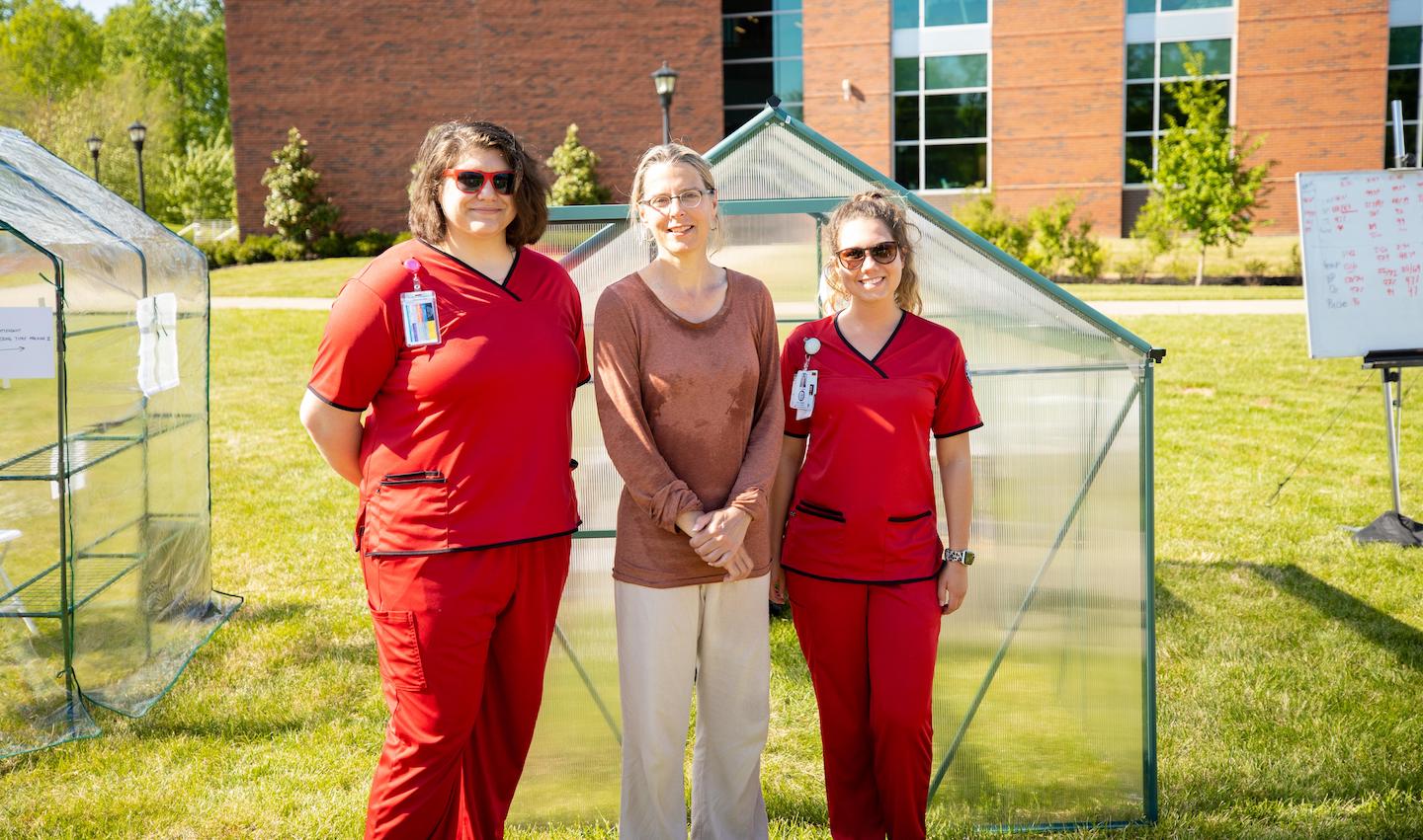 On Earth Day, the Art + Design lawn at Austin Peay State University had an interesting sight to see. Eliza Evans, an environmental artist of about 10 years, was taking part in a durational performance piece where she spent several hours in a “time machine.” This time machine, a commercial greenhouse, helped to show what the future may look like on Earth. Instead of using statistics and graphs to indicate the changes in the environment, Evans used her body as a proxy. During this performance, Evans stayed in the time machine for seven hours. Through this, the experiment showed how the human body copes with the effects of the environment, much like the Earth. “This is just an experiment for me to try to anticipate what the world might be like towards the end of my life,” Evans said. Evans referred to this art piece as a “personal exploration.” She also shared the experience with those brave enough to step into the time machine. I had the opportunity of experiencing what Eliza was while also getting to know her better. I stayed in the time machine for a little over 13 minutes, but only a few minutes in, I felt extremely uncomfortable. Evans discussed how our shared traits allow us to adapt and create solutions together to combat issues we face. “We have a problem, and we don’t know how bad it is going to be. We need to help each other,” Evans said. This is not Evans’ first time undergoing this durational performance piece. When Evans was on an artist’s residency in New York, she put out a greenhouse on a lawn as an experiment to see what would happen. Evans said the people who brought her fruit and ice on their own showed her how beautiful this experiment is. “They just pitched in,” Evans said. “That wasn’t even a question I posed.” The experiment Evans participated in on APSU’s campus had more structure. In the first experiment Evans conducted, she kept track of her heart rate thinking she could take care of her own health. This performance was also a collaboration with the APSU School of Nursing. Nursing students took Evans’ vitals throughout her performance to see how the heat was affecting her. “This project has already created a context for the community nursing projects on water quality and community health,” Evans said. “These two projects are in conversation with each other which I think is phenomenal.” Evans’ goal is to make people aware of the effects Earth is undergoing. “Even if they disagree, even if someone isn’t quite convinced that climate change is real or that it’s caused by humans, people have positions all along the spectrum, and I’m willing to engage with any,” Evans said. Evans said she finds conversations with others about her art is a rewarding part of the process. Evans saw the Earth Day performance as a perfect opportunity to help bring awareness to climate change and its effects on the Earth. “Every day is Earth Day to me,” Evans said. Visit Evans’ website to learn more about her work. The performance was sponsored by the Department of Art + Design with support from The Center of Excellence for the Creative Arts.