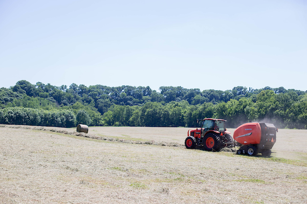 A tractor rolls hay at the APSU farm.