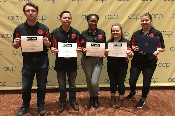 Staff members with the All State show off their awards