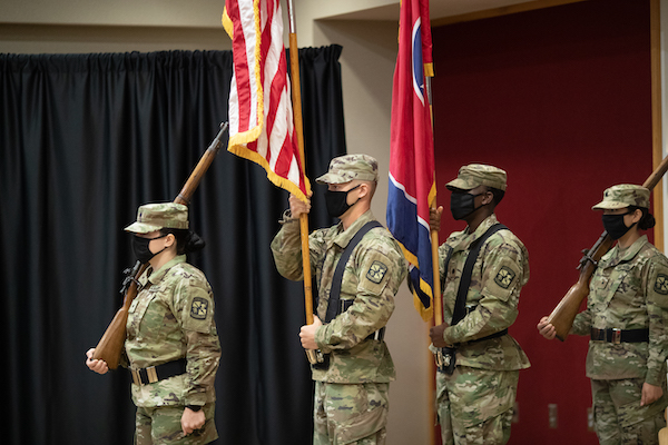 APSU ROTC cadets wear masks while presenting the flag at a ceremony.