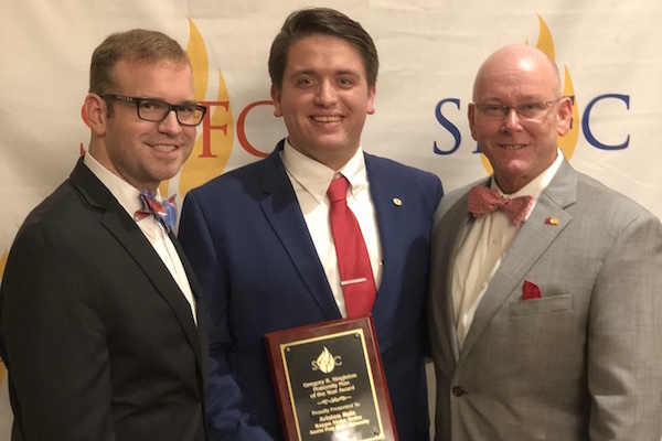 Stephen Dominy, Ari Ruiz and Greg Singleton gather after Ruiz received his man of the year award.