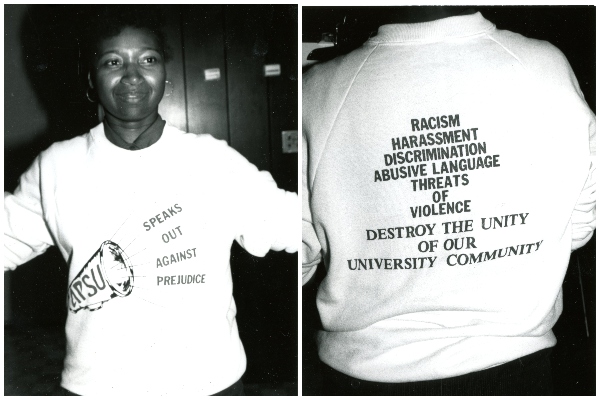 A black and white photo from the 1990s of an unnamed individual wearing a sweatshirt proclaiming APSU is against racism. 