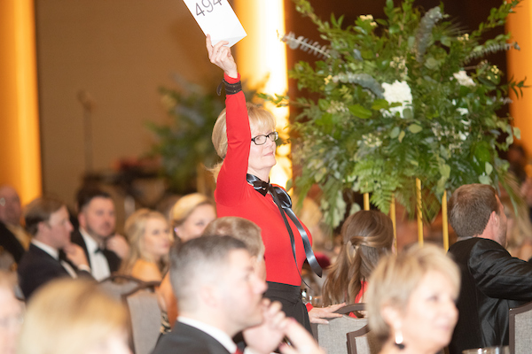 An attendee at last year's ball bids on an item.