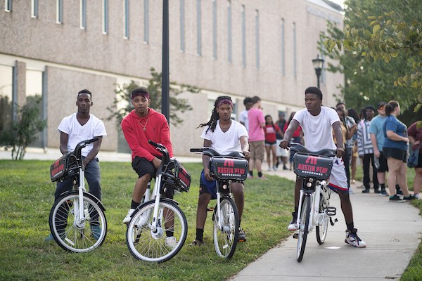 Students sit on the new bikes.