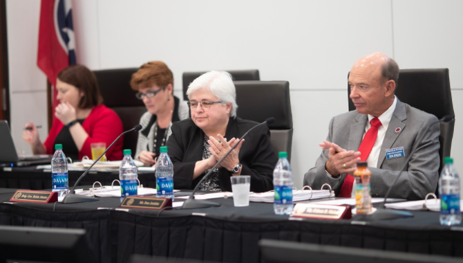 The board members sitting at the table during a meeting in 2017.