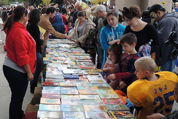 Children look through books at a previous Candy For the Mind event.