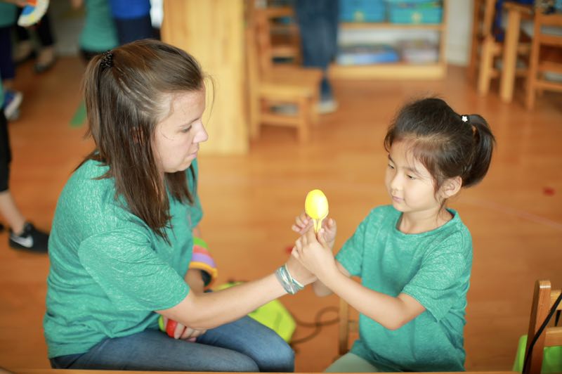 Amanda Crumb works with a young student at a summer camp in Beijing. 