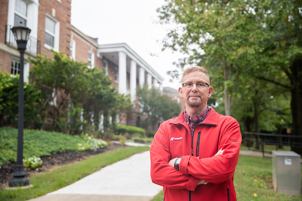 William Cody stands in front of Harned Hall.