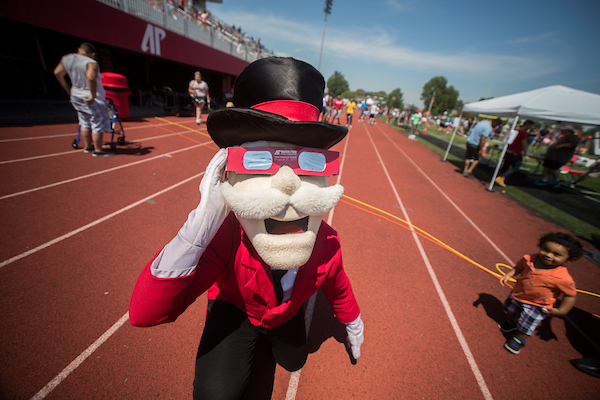 The Gov wears safety glasses during the eclipse.