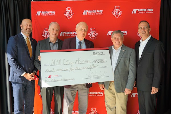 A giant check is presented to Mickey Hepner, dean of the APSU College of Business.