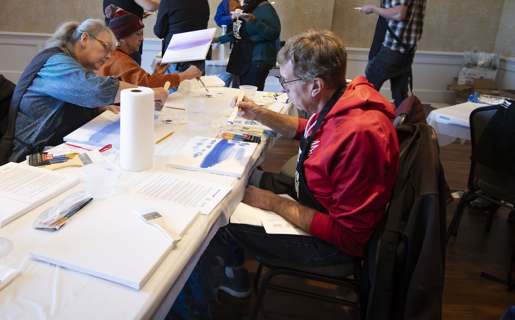 Community members learn basic painting techniques during a free CSA workshop.