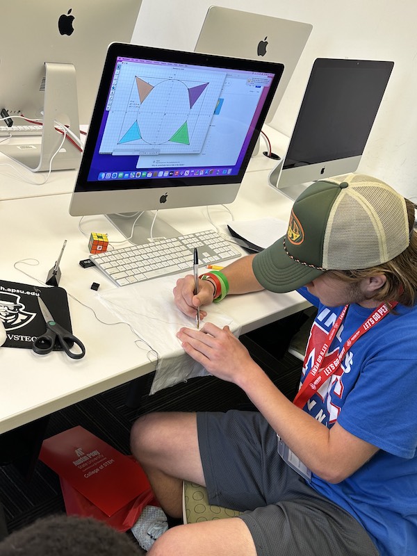 A student designs a makeshift parachute at APSU's SOARing with Mathematics summer camp.