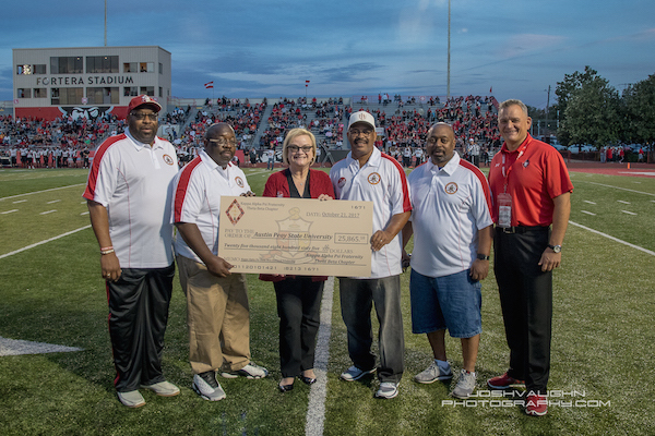 Alumni members of the Kappa Alpha Psi fraternity present APSU President Alisa White with a $25,000 check.