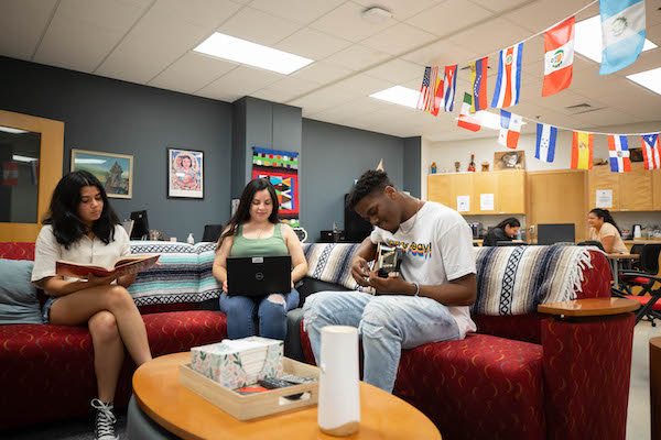 Students sit and enjoy lounging on couches at the Latino Community Resource Center.