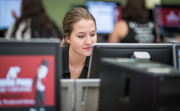 A student conducts research on a library computer