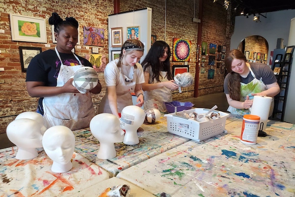 Volunteers with Austin Peay State University create paper mache heads in support of an event at the Hart Gallery in Chattanooga, Tennesse as part of their Alternative Break trip. 