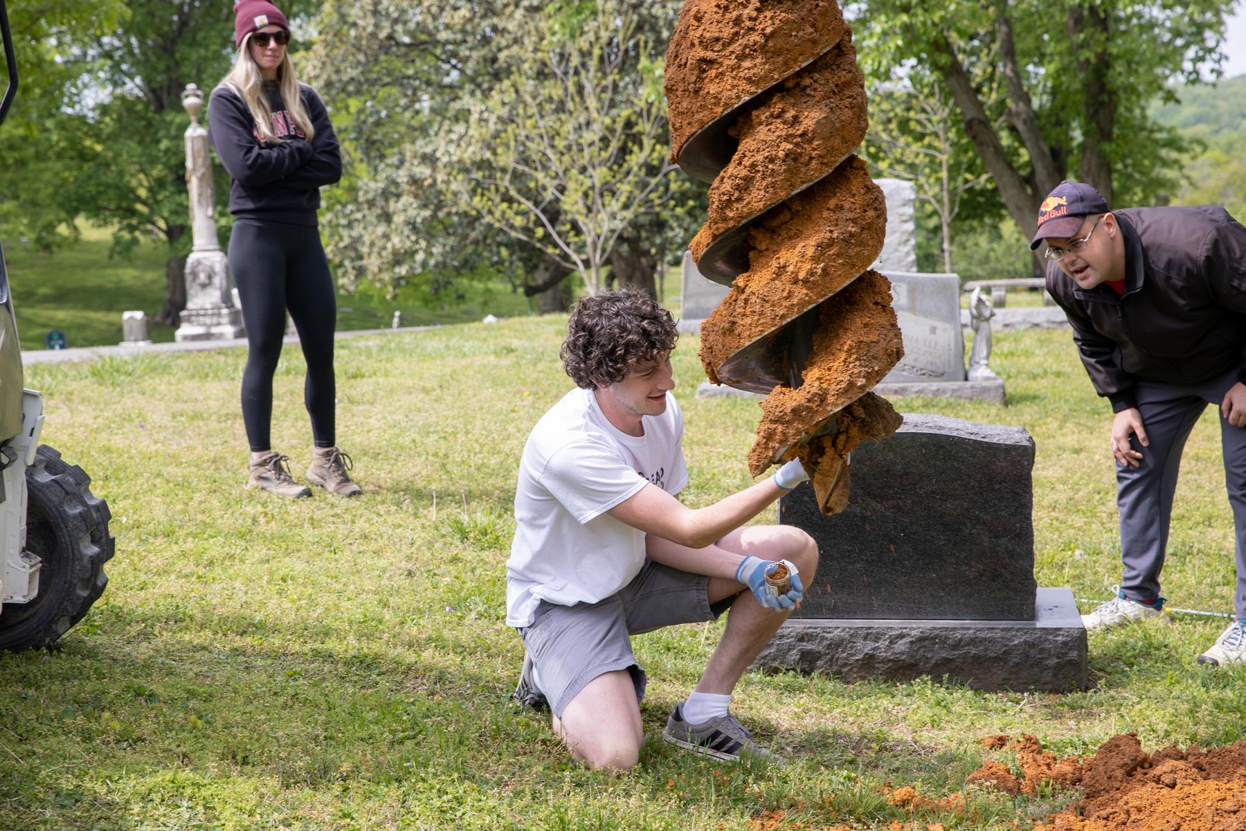 Patrick Richardson, a health and human performance major, helps collect soil samples from Clarksville's Riverview Cemetery as part of a student research project. 