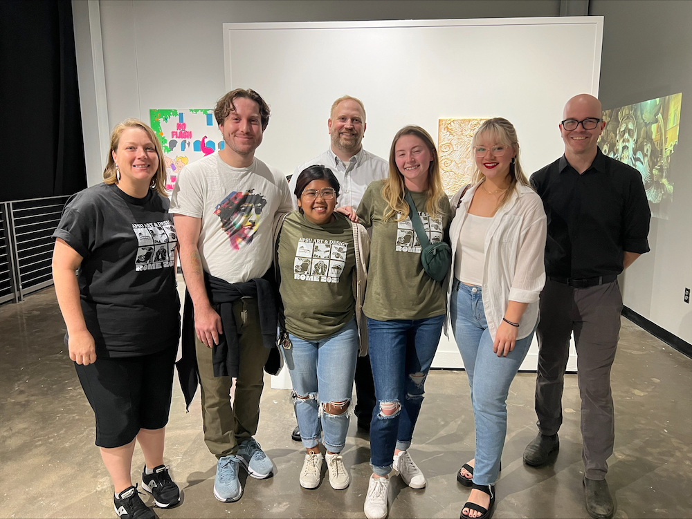 During the reception of the study abroad exhibition, students from the program were photographed alongside Dr. Tamara Smithers, Master Sgt. Christopher Sanderford, and Professor Patrick Vincent.