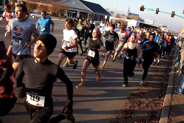 Runners in fall clothing participate, amid falling leaves, in the annual 5K race.