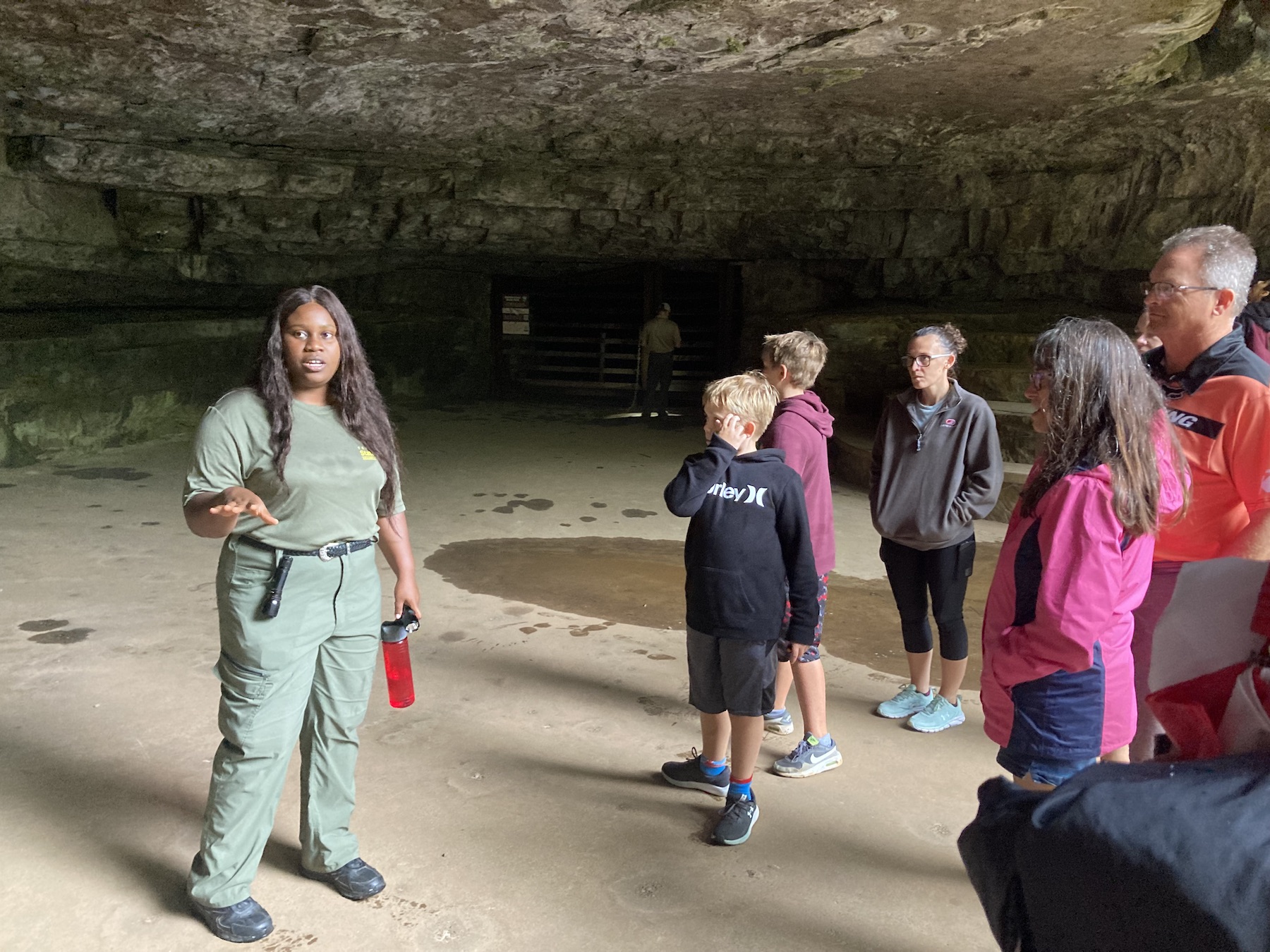 Graduate history student Ifunanya Ejimofor leads a guided tour through Dunbar Cave.