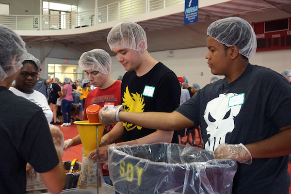 Students prepare meals during the Freshman Service Project. 