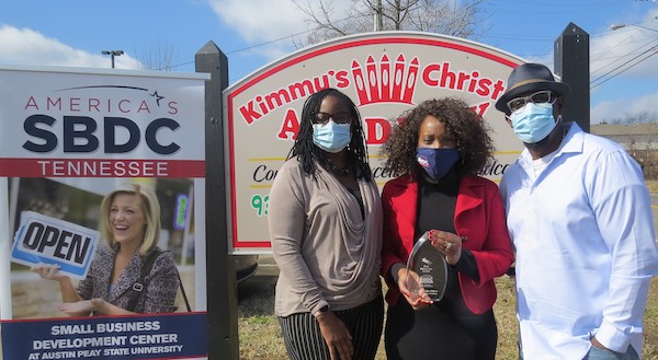 Lorneth Peters presents an award to Martin and Kim Hines.