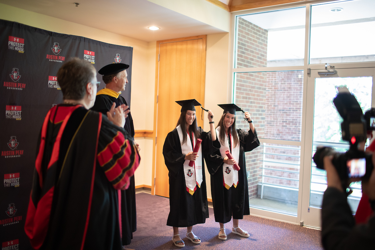 Lidia Yanes Garcia, left, and Claudia Yanes Garcia move their tassels to the left during the ceremony.