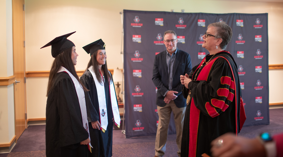 Austin Peay President Alisa White talks to Lidia Yanes Garcia, left, and Claudia Yanes Garcia prior to their commencement.
